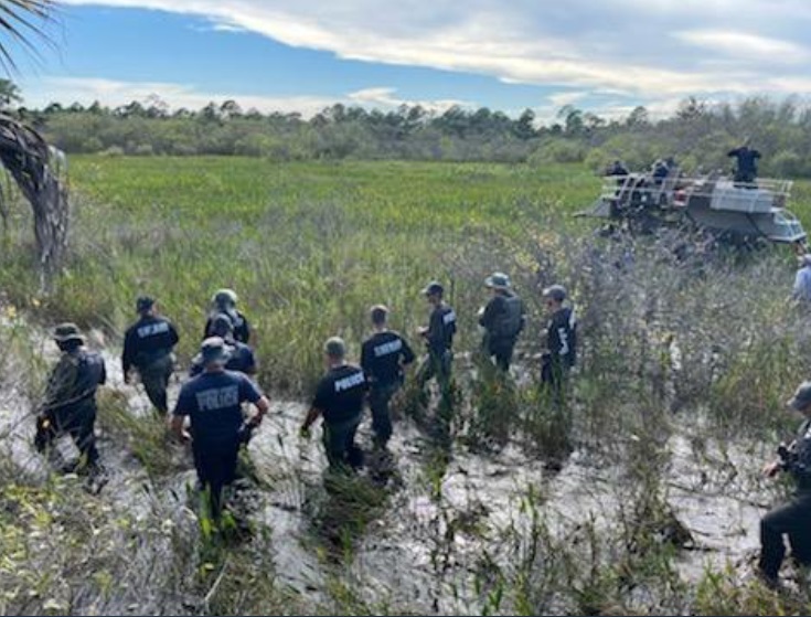 PHOTO 15 North Port Police Officers Searching Deep Terrain For Brian Laundrie On September 23rd