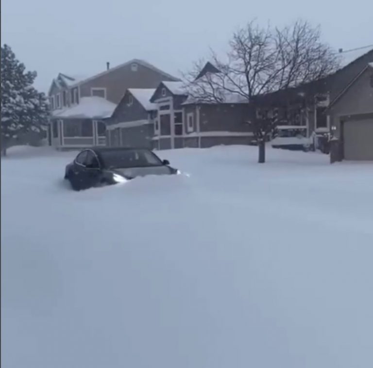 photo tesla model s using snowplow mode to out of 1 foot of snow in denver