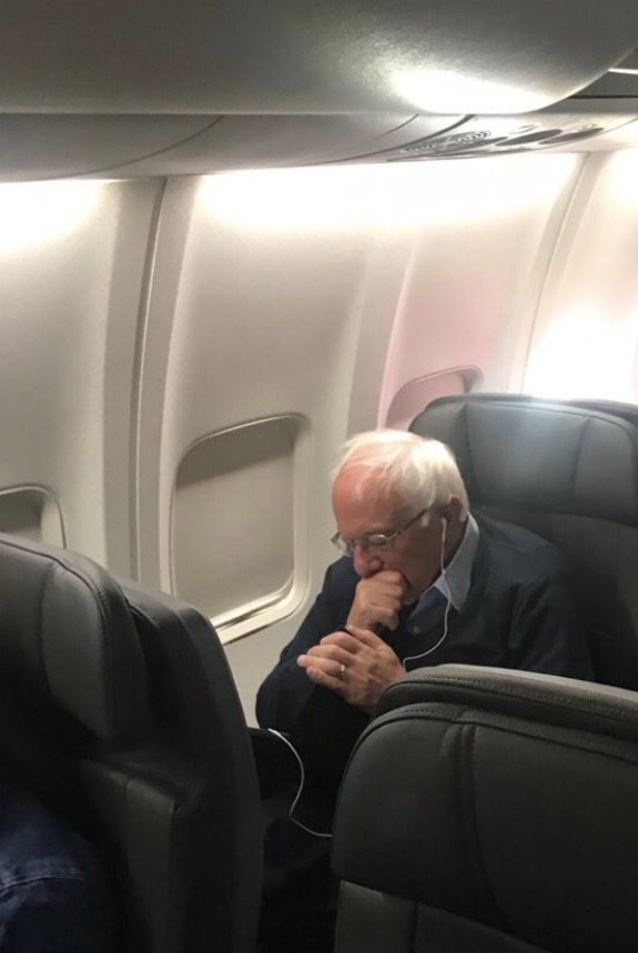 PHOTO Bernie Sanders Listening To Music On Plane With Apple Earbuds