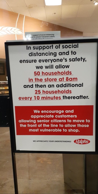 PHOTO Ralph's Grocery Store In Los Angeles Sign That Says Only 25-50 Households Allowed In Store At Once