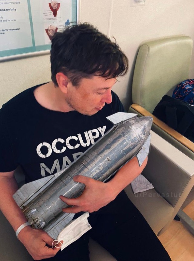 PHOTO Elon Musk Holding A Rocket Like A Baby